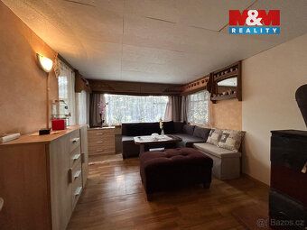 We offer for sale a garden with caravan on the edge of a quiet village