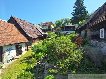 Wooden house with red roof in picturesque village of Orava, ready for immediate use.